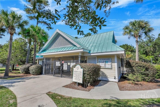 204 Bristol Way, Richmond Hill, GA 31324 - view of front of home featuring a standing seam roof, a gate, and a metal roof
