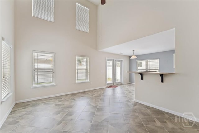 205 Summer Hill Ct, Richmond Hill, GA 31324 - unfurnished living room featuring light tile patterned flooring and a high ceiling