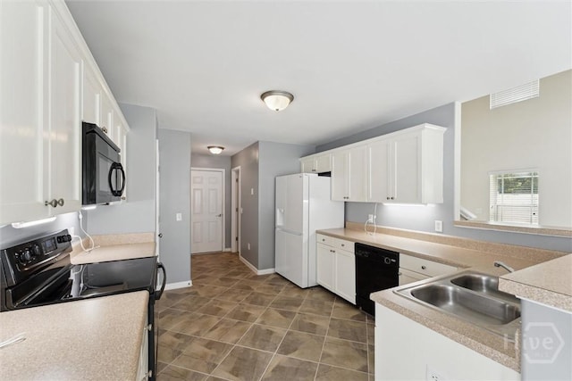 205 Summer Hill Ct, Richmond Hill, GA 31324 - kitchen featuring black appliances, white cabinetry, light countertops, and tile patterned flooring