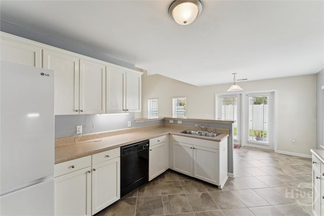 205 Summer Hill Ct, Richmond Hill, GA 31324 - kitchen featuring freestanding refrigerator, dishwasher, a peninsula, white cabinetry, and light tile patterned floors