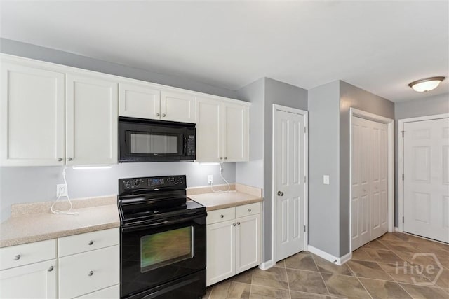 205 Summer Hill Ct, Richmond Hill, GA 31324 - kitchen with black appliances, white cabinetry, and light countertops