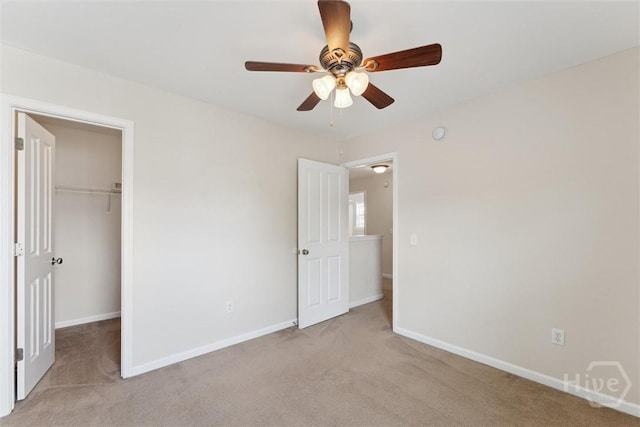 205 Summer Hill Ct, Richmond Hill, GA 31324 - unfurnished bedroom with light colored carpet, a spacious closet, and a ceiling fan