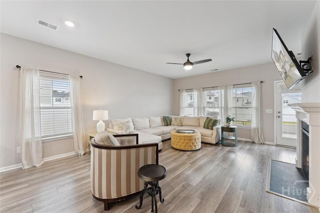 103 Williams Dr, Rincon, GA 31326 - living room featuring light wood finished floors, a warm lit fireplace, and ceiling fan
