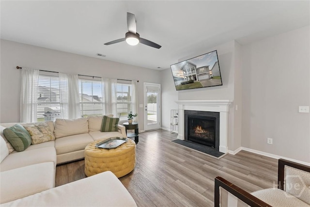 103 Williams Dr, Rincon, GA 31326 - living room featuring a fireplace with flush hearth, wood finished floors, and a ceiling fan