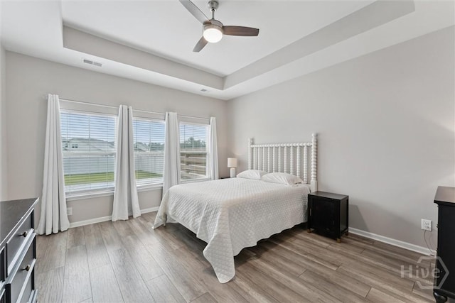 103 Williams Dr, Rincon, GA 31326 - bedroom featuring a tray ceiling, wood finished floors, and ceiling fan