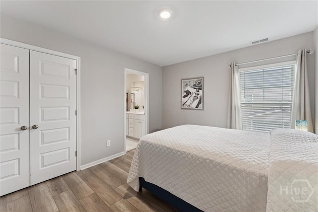103 Williams Dr, Rincon, GA 31326 - bedroom with wood finished floors, a closet, and ensuite bathroom