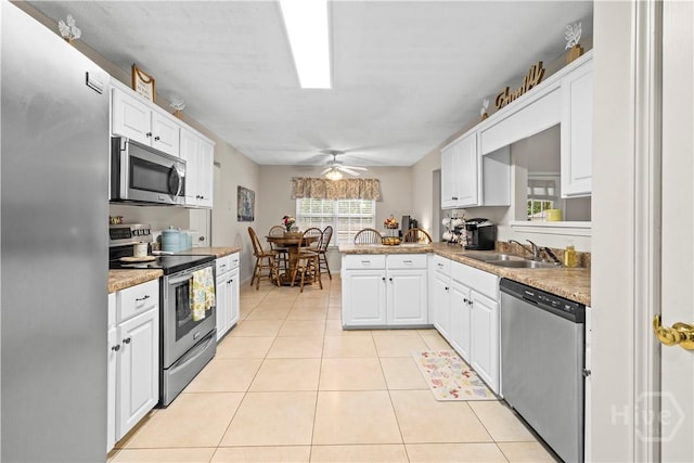 11 Rialto Ct, Pooler, GA 31322 - kitchen with appliances with stainless steel finishes, a ceiling fan, white cabinetry, light tile patterned floors, and a peninsula