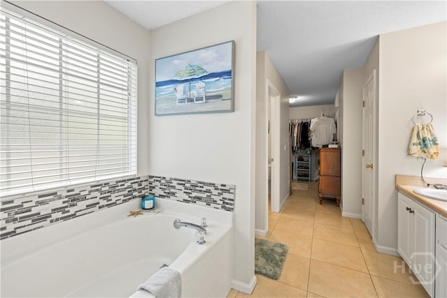 11 Rialto Ct, Pooler, GA 31322 - bathroom featuring a garden tub, vanity, tile patterned floors, and a spacious closet