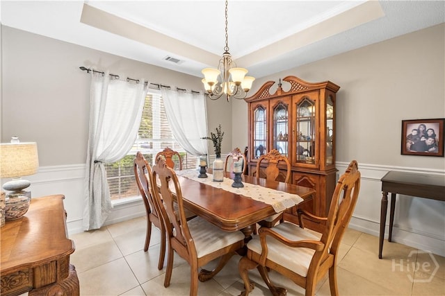 11 Rialto Ct, Pooler, GA 31322 - dining area with a chandelier, a tray ceiling, light tile patterned floors, and wainscoting