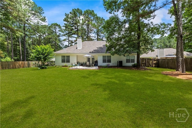 11 Rialto Ct, Pooler, GA 31322 - back of property featuring a patio area, a fenced backyard, a chimney, and a shingled roof