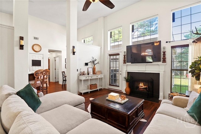 117 Barrington Rd, Pooler, GA 31322 - living room featuring a towering ceiling, ceiling fan, a lit fireplace, and wood finished floors