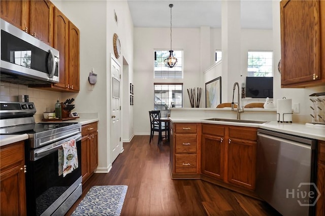 117 Barrington Rd, Pooler, GA 31322 - kitchen featuring appliances with stainless steel finishes, dark wood-type flooring, decorative backsplash, a peninsula, and light countertops