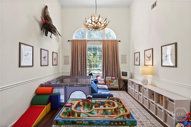 117 Barrington Rd, Pooler, GA 31322 - recreation room with a high ceiling, a chandelier, and crown molding