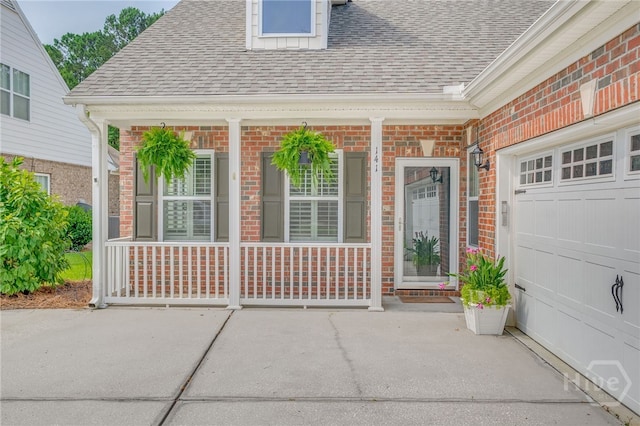 141 Regency Cir, Pooler, GA 31322 - property entrance featuring a shingled roof, brick siding, and covered porch