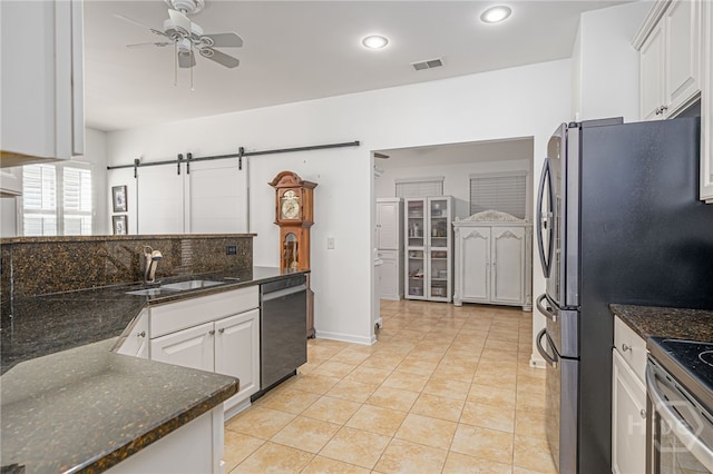 141 Regency Cir, Pooler, GA 31322 - kitchen featuring appliances with stainless steel finishes, a ceiling fan, a barn door, white cabinetry, and recessed lighting