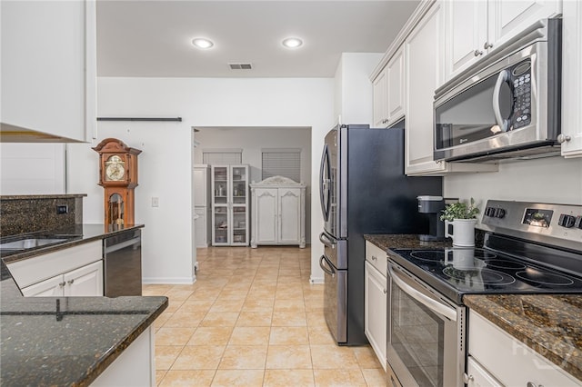 141 Regency Cir, Pooler, GA 31322 - kitchen featuring stainless steel appliances, light tile patterned floors, dark stone counters, white cabinetry, and recessed lighting