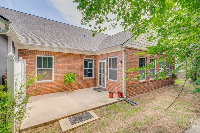 141 Regency Cir, Pooler, GA 31322 - rear view of house with brick siding, roof with shingles, and a patio area