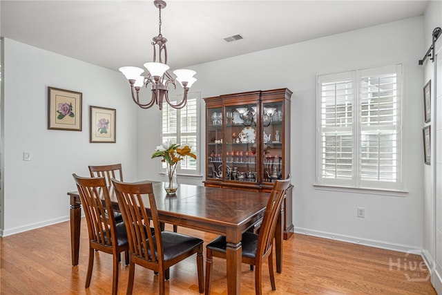 141 Regency Cir, Pooler, GA 31322 - dining area featuring a chandelier and light wood-type flooring