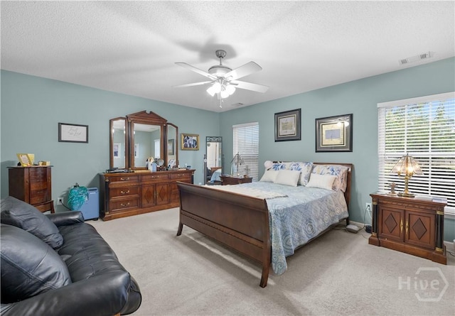 335 Winchester Dr, Pooler, GA 31322 - carpeted bedroom with multiple windows, a textured ceiling, and a ceiling fan