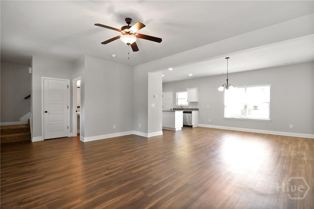 302 Morgan Pines Dr, Pooler, GA 31322 - unfurnished living room featuring a ceiling fan, a chandelier, dark wood-type flooring, and stairway