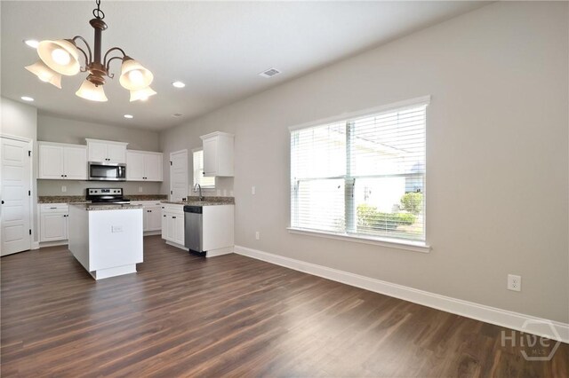 302 Morgan Pines Dr, Pooler, GA 31322 - kitchen with appliances with stainless steel finishes, a chandelier, dark wood-style floors, white cabinetry, and a kitchen island