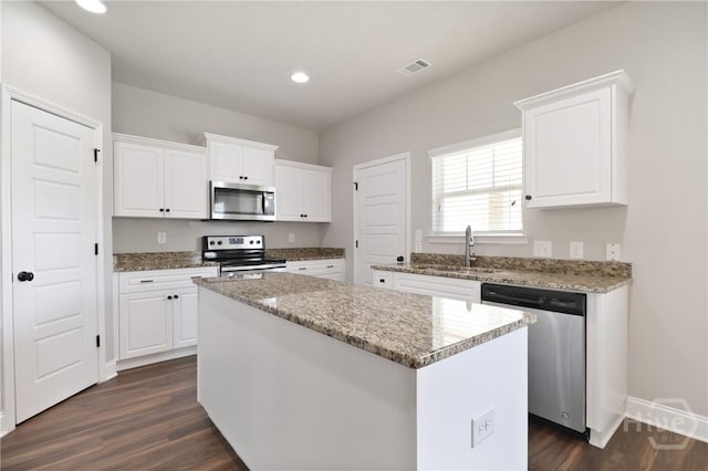 302 Morgan Pines Dr, Pooler, GA 31322 - kitchen featuring stainless steel appliances, a center island, white cabinetry, dark wood-style flooring, and recessed lighting