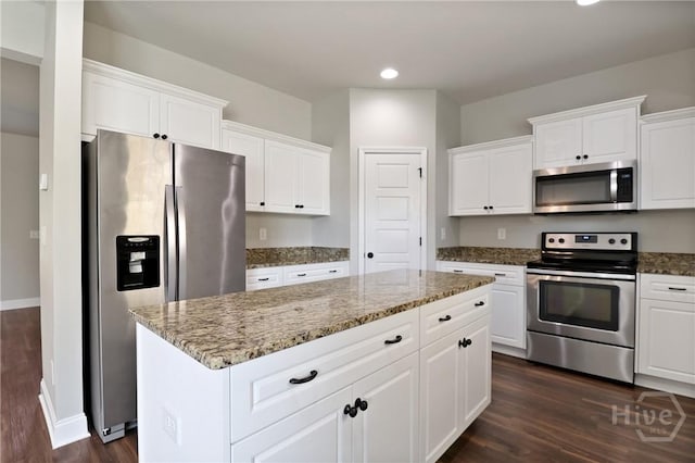 302 Morgan Pines Dr, Pooler, GA 31322 - kitchen featuring appliances with stainless steel finishes, dark wood finished floors, recessed lighting, a center island, and white cabinetry