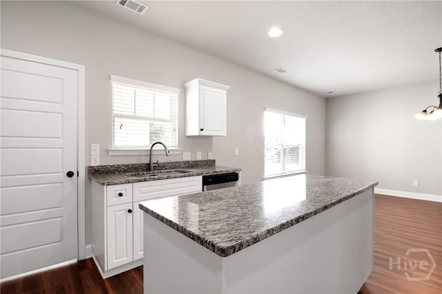 302 Morgan Pines Dr, Pooler, GA 31322 - kitchen with dark wood-type flooring, white cabinetry, recessed lighting, dark stone counters, and a kitchen island