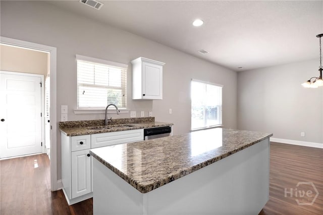 302 Morgan Pines Dr, Pooler, GA 31322 - kitchen with dark wood finished floors, dishwasher, white cabinetry, a center island, and dark stone counters