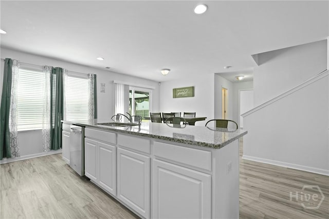 13 Summer Place Dr, Guyton, GA 31312 - kitchen with white cabinets, a kitchen island with sink, dishwasher, light stone countertops, and recessed lighting