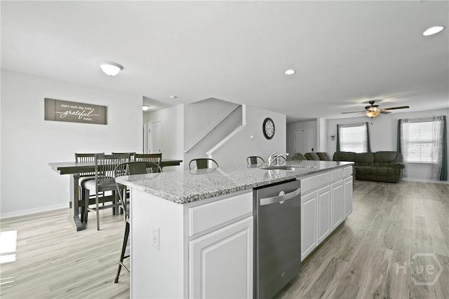 13 Summer Place Dr, Guyton, GA 31312 - kitchen featuring stainless steel dishwasher, a ceiling fan, a kitchen island with sink, white cabinetry, and light wood-style flooring