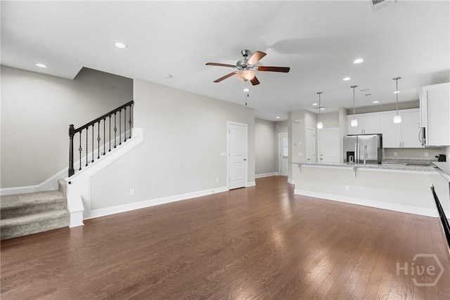 160 Lake Lily Dr, Richmond Hill, GA 31324 - unfurnished living room featuring ceiling fan, recessed lighting, stairs, and dark wood-style floors