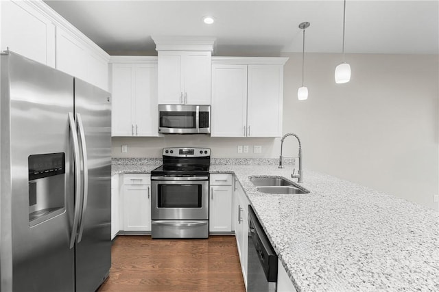 160 Lake Lily Dr, Richmond Hill, GA 31324 - kitchen with appliances with stainless steel finishes, white cabinetry, light stone countertops, dark wood-style flooring, and recessed lighting