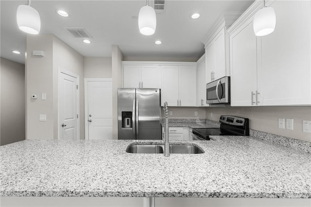 160 Lake Lily Dr, Richmond Hill, GA 31324 - kitchen with appliances with stainless steel finishes, light stone countertops, white cabinetry, recessed lighting, and a peninsula