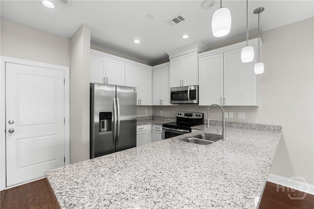 160 Lake Lily Dr, Richmond Hill, GA 31324 - kitchen with stainless steel appliances, a peninsula, white cabinets, dark wood-style flooring, and recessed lighting
