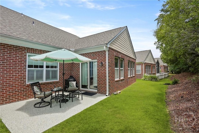 137 Regency Cir, Pooler, GA 31322 - rear view of house with brick siding, a shingled roof, a lawn, and a patio area