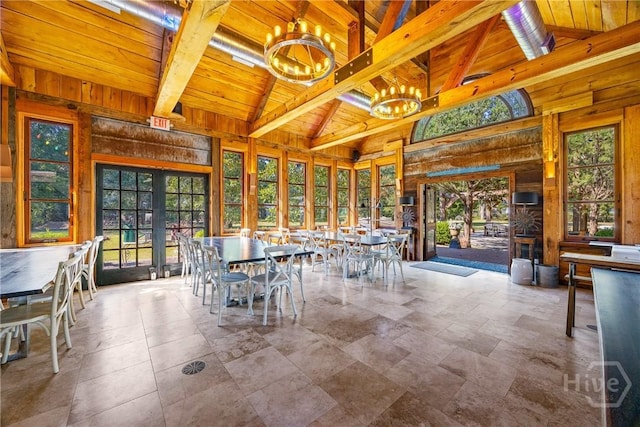438 Kessler Loop, Guyton, GA 31312 - unfurnished dining area featuring a chandelier, wooden ceiling, french doors, and wood walls
