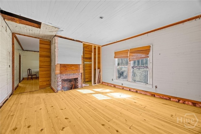 438 Kessler Loop, Guyton, GA 31312 - unfurnished living room featuring a fireplace, wood-type flooring, wooden ceiling, and wooden walls