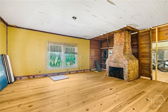 438 Kessler Loop, Guyton, GA 31312 - unfurnished living room featuring wood finished floors, a brick fireplace, plenty of natural light, wooden walls, and wooden ceiling