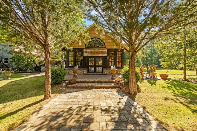 438 Kessler Loop, Guyton, GA 31312 - view of exterior entry featuring french doors and a yard