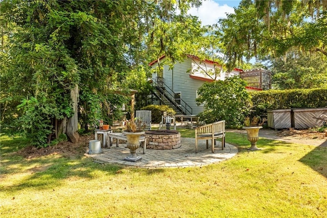 438 Kessler Loop, Guyton, GA 31312 - view of grassy yard featuring a fire pit and stairway