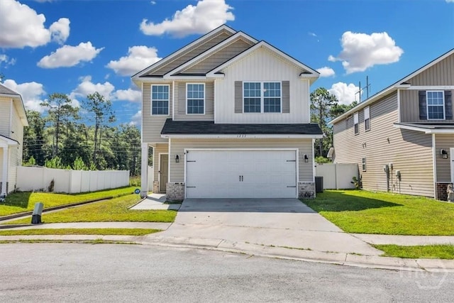 1237 Cypress Fall Cir, Hinesville, GA 31313 - view of front of home featuring a garage, driveway, board and batten siding, and stone siding