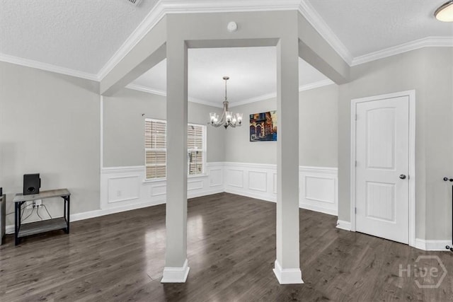 1237 Cypress Fall Cir, Hinesville, GA 31313 - entrance foyer featuring dark wood finished floors, a chandelier, a wainscoted wall, and ornamental molding