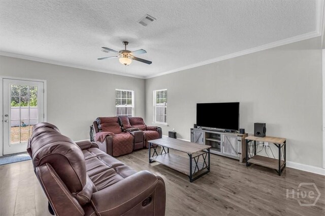 1237 Cypress Fall Cir, Hinesville, GA 31313 - living area with wood finished floors, crown molding, ceiling fan, and a textured ceiling