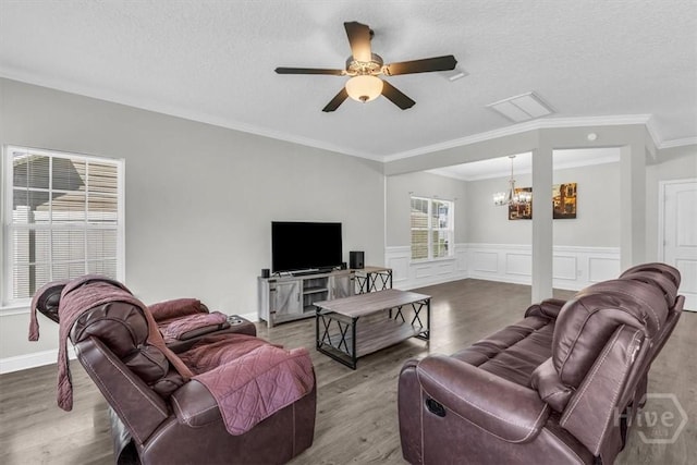 1237 Cypress Fall Cir, Hinesville, GA 31313 - living area featuring a chandelier, a ceiling fan, a textured ceiling, wood finished floors, and ornamental molding