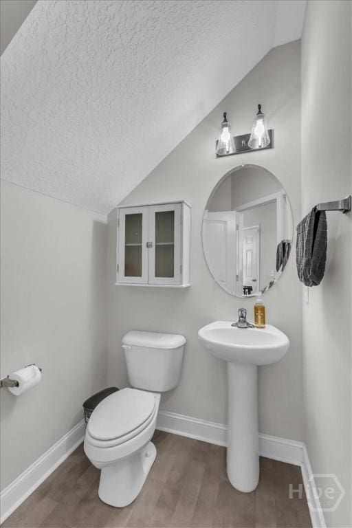 1237 Cypress Fall Cir, Hinesville, GA 31313 - bathroom featuring lofted ceiling, a textured ceiling, and wood finished floors
