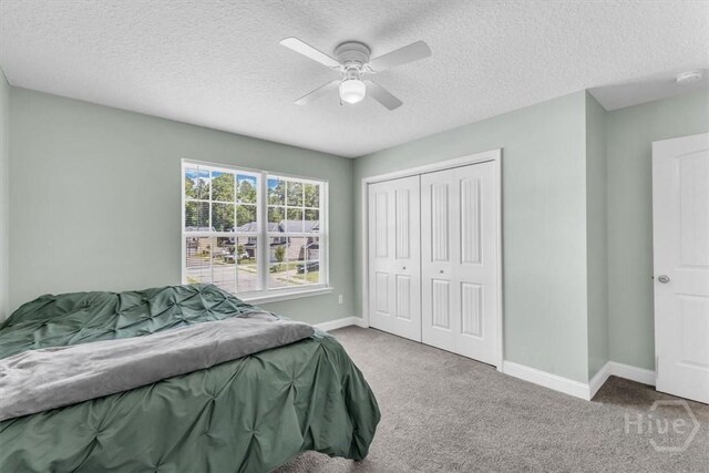 1237 Cypress Fall Cir, Hinesville, GA 31313 - carpeted bedroom featuring a textured ceiling, a closet, and ceiling fan