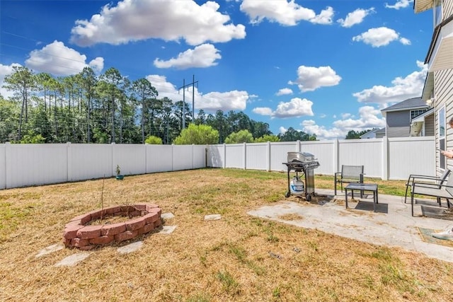 1237 Cypress Fall Cir, Hinesville, GA 31313 - fenced backyard with an outdoor fire pit and a patio