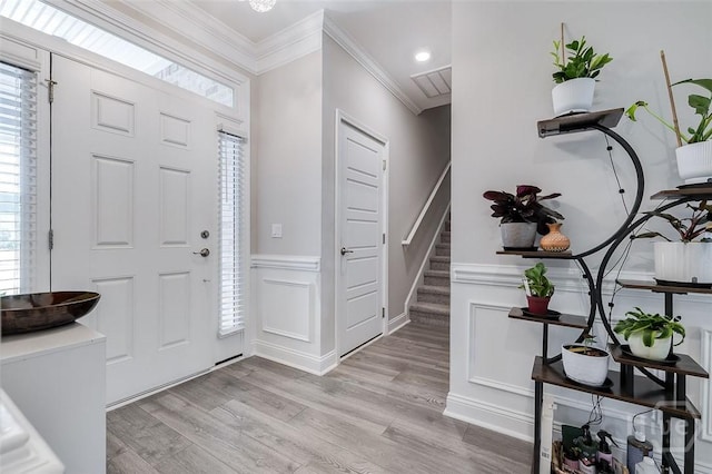 127 Champlain Dr, Pooler, GA 31322 - foyer entrance featuring wainscoting, light wood finished floors, healthy amount of natural light, ornamental molding, and stairway