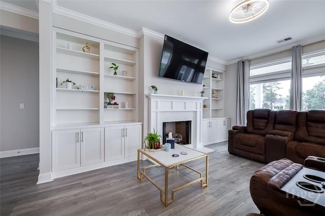 127 Champlain Dr, Pooler, GA 31322 - living room featuring wood finished floors, crown molding, built in shelves, and a fireplace